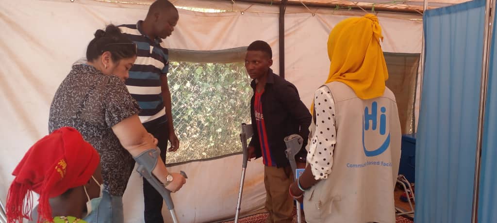 With the PT and translator, we are showing the boy an alternative assistive device (elbow crutches) from what he uses now (axillary crutches)