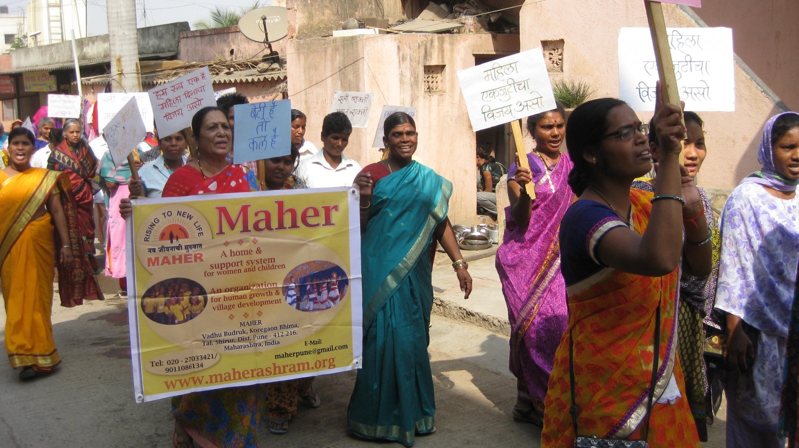 Maher women in a village near Pune march on International Women's Day as Maher's founder receives an award in New Delhi from India's President.