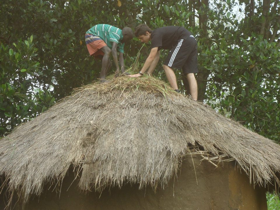 A Volunteer helping in building a hut