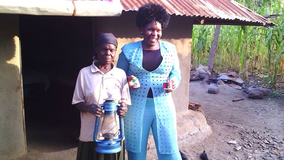 One lady in the community demonstrates how after acquiring solar lantern, she saves the paraffin money is a small bottle which is helping her pay school fees