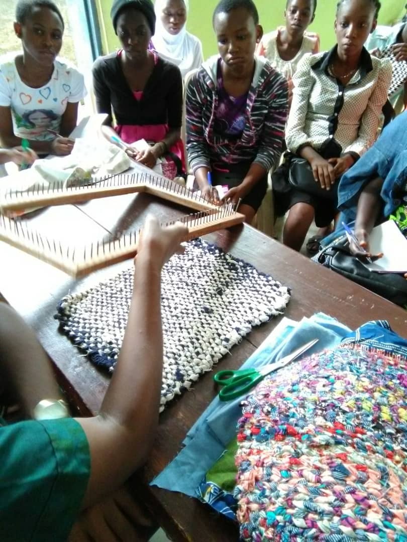 Our first day of training with Nana teaching the girls how to make rag-mat with loom and pieces of fabrics