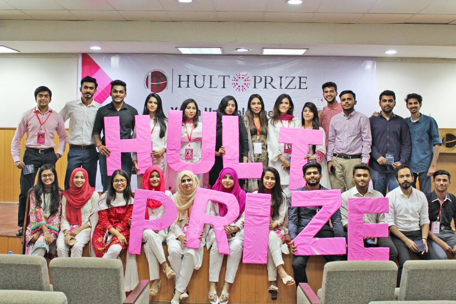 Organizing team with Hult Prize cutouts