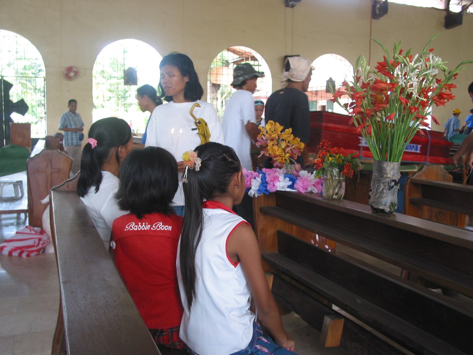 The children sat on a pew at the church. Photo by libudsuroy, March 19, 2007. Creative Commons.