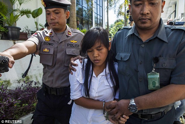 Mary Jane on the way to court, flanked by police officers. Photo by Reuters