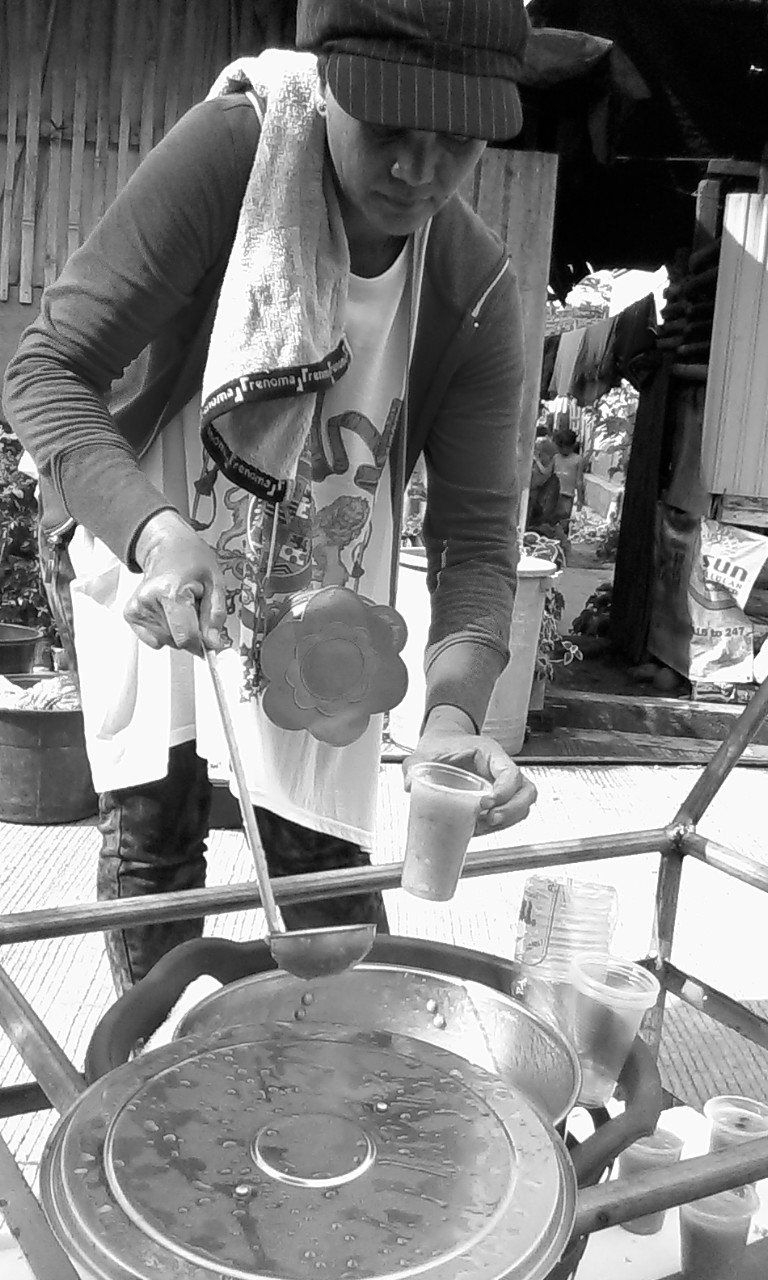 A widow sells binignit, a creamy concoction of rootcrops and ripe bananas cooked in coconut cream. She places the big pot of hot food on a pushcart and peddles her product along the resettlement's streets.Photo by libudsuroy. CreativeCommons
