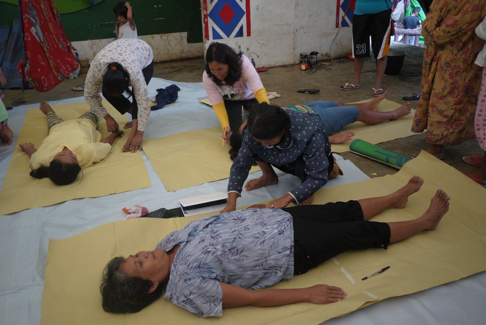 Participants take turns in tracing the contours of each other's bodies. Photo courtesy of MIILS