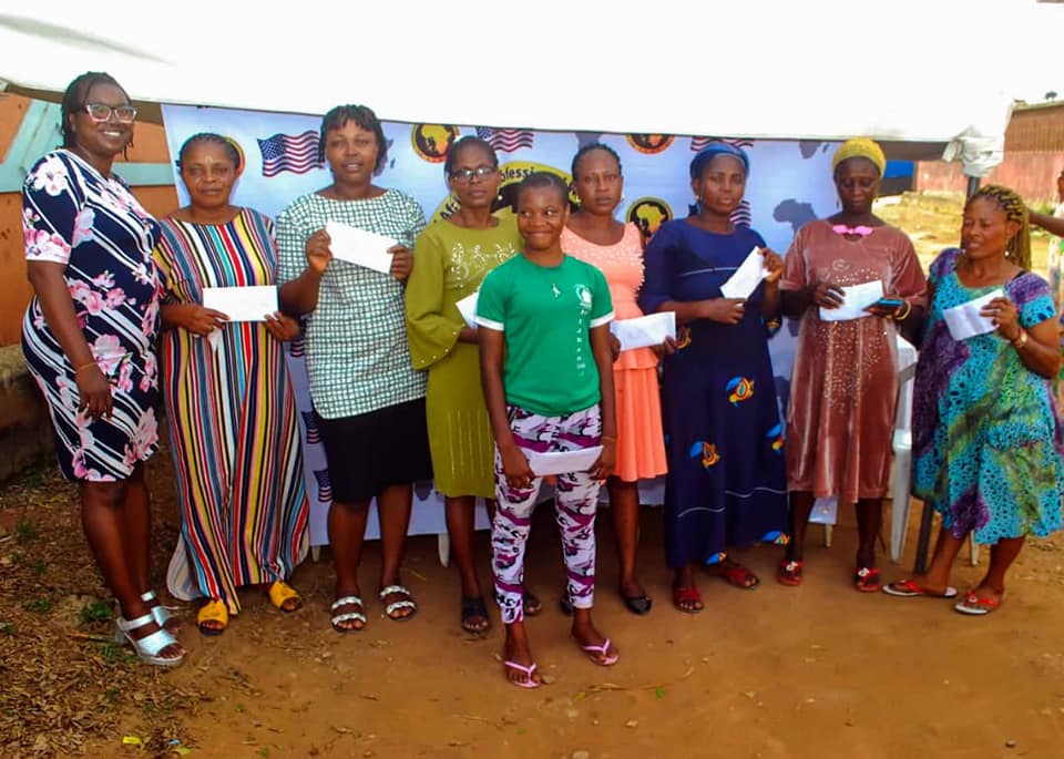 Cross-section of the widows with their cash awards and one of our team member.