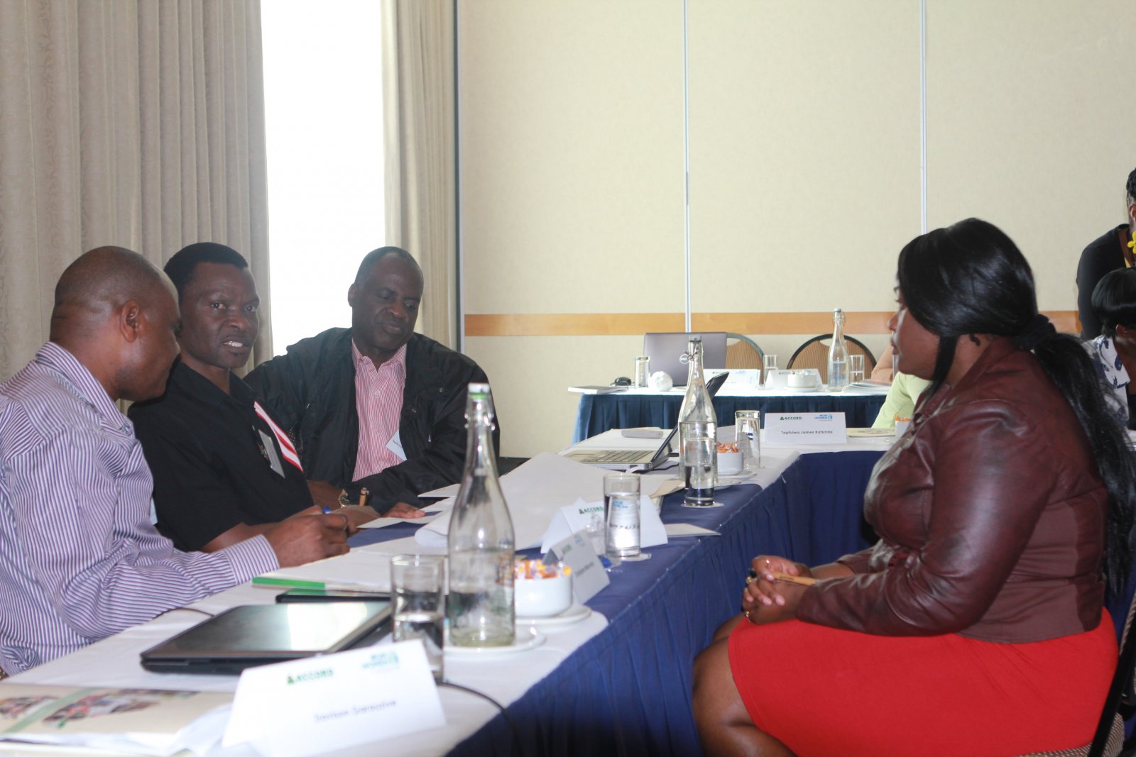 Daisy Mbuto, Accord Intern chats with participants from Zimbabwe